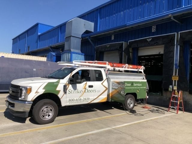 Strike Doors service truck at a warehouse loading dock